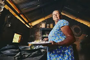 Smell Prints: Rural woman preparing food in traditional home kitchen. Domestic life in Sri Lanka