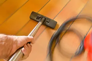Floors Prints: rush action and movement detailed view of hover nozzle being swept over carpets tiles wooden floor cleaning up dirt