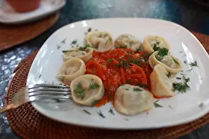 Siberian Prints: Russian pelmeni with vegetable salsa on a white plate