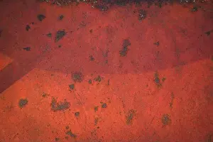 Scratched Prints: Rusty metal surface covered with red paint with spots