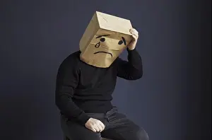 Tear Prints: A sad man in a black turtleneck with a bag on his head