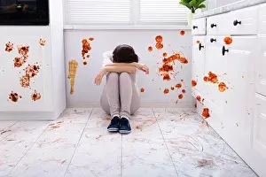 Trouble Prints: Sad Woman Sitting On Floor With Spilled Food In Kitchen