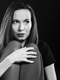 Despair Prints: Sad woman vivid color pantyhose sitting on couch black white photo