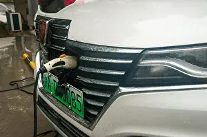 Electric Vehicle Prints: An SAIC Roewe eRX5 EV400 as offered by car sharing scheme EVcard being charged at an EVCard station