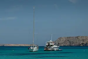 Greek Islands Prints: Two sailboats anchored in the clear blue waters of Gramvousa