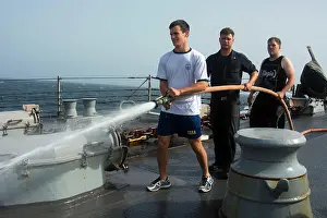 Capability Prints: Sailors perform a freshwater wash-down on the guided-missile destroyer USS Mason (DDG 87)
