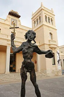 Surrealism Prints: Saint John the Baptist sculpture by Salvador Dali in front of the Archaeological Museum of Alicante