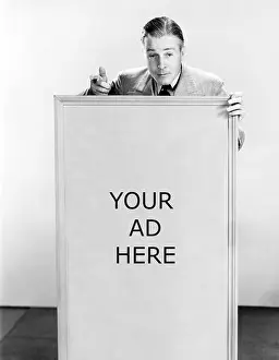 Posed Prints: Salesman with sign saying buy now