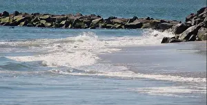 Salt Water Prints: Salt water form ocean breaking waves against the beach and jetty rocks with ducks feeding and ocean background