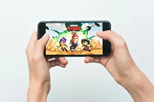Samara, Russia -07, 29, 2019: A young guy playing brawl stars game on Iphone 8 Plus