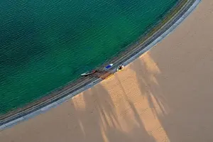 Sowing Prints: Sand beach aerial, top view of a beautiful sandy beach aerial shot with the blue waves rolling into the shore