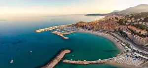 Sand beach beneath the colorful old town Menton on french Riviera, France. Drone aerial view over Menton France Europe
