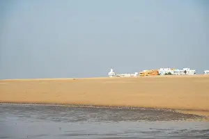 Huelva Prints: sand beach at Isla Cristina at the Costa de la Luz in Andalusia with view to town and lighthouse