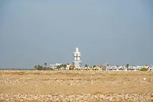 Huelva Prints: sand beach at Isla Cristina at the Costa de la Luz in Andalusia with view to town and lighthouse