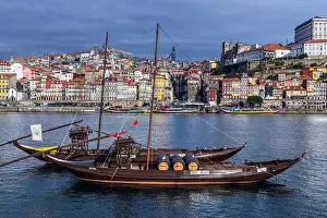 Sandeman and Porto Cruz Port wine boats called Rabelo Boats on a Douro River in Vila Nova de Gaia city