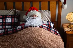 Exhausted Prints: Santa Claus sleeping in his bed at the North Pole after his Christmas Eve deliveries