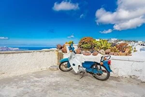 Images Dated 17th May 2019: Santorini caldera view with old scooter, white architecture and traditional travel landscape