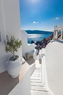 Santorini, Greece. Picturesque view of traditional cycladic Santorini houses on cliff, steps with endless sea view. Amazing travel landscape, idyllic