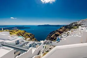 Santorini Island, filled with cafes and hotels overlooking the Aegean Sea and volcanic Caldera. Luxury summer travel and vacation destination of white