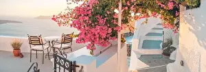 Santorini island sunset. Caldera view with chairs and flowers, romantic mood, couple travel vacation landscape destination scenic. Tourism romance