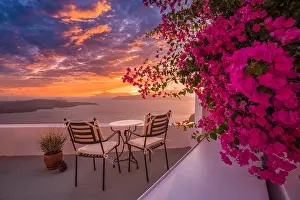 Romance Prints: Santorini island sunset. Caldera view with street and flowers