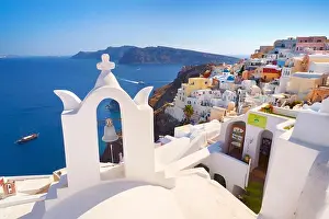Santorini landscape with white greek bell tower and sea in the background - Oia Town, Santorini Island, Cyclades, Greece