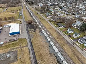 Bradford Prints: Sayre, PA, USA - 03-03-2024 - Cloudy winter aerial image of a bulk materials railroad car near downtown area