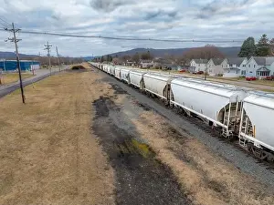 Bradford Prints: Sayre, PA, USA - 03-03-2024 - Cloudy winter aerial image of a bulk materials railroad car near downtown area