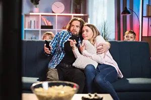 Hiding Prints: Scared bearded husband hugging his frightened wife during