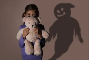 Panic Prints: Scared little girl with teddy bear suffering from sciophobia and phantom behind her
