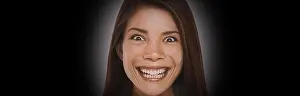 Cruel Prints: Scary face expression of crazy Asian girl with evil smile on black background banner