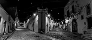 Street Light Prints: Scenic abandoned street in the Trulli district of Alberobello at night, Southern Italy