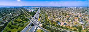 Scenic aerial panorama of highway interchange in greater Melbourne suburbs on sunny day