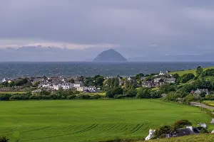 Ayrshire Prints: Scenic coastal village of Ballantrae with green fields and Ailsa Craig on the horizon