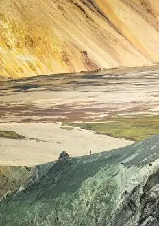 Scenic drone view of snowy valley surrounded with mountains on sunny day in Iceland