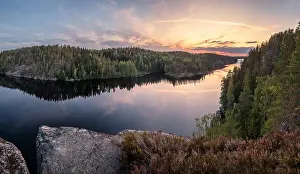 Scenic forest landscape with tranquil mood and idyllic sunset at summer evening in Finland