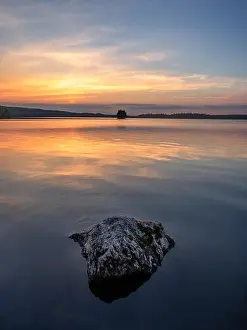 Scenic landscape with beautiful sunset and lake at summer evening in Finland