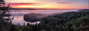 Scenic landscape with lake, sunrise and fog at tranquil misty morning in Aulanko, nature reserve, Finland