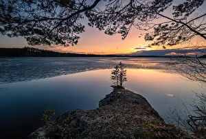 Scenic landscape with melting lake and sunset at beautiful spring evening in Finland