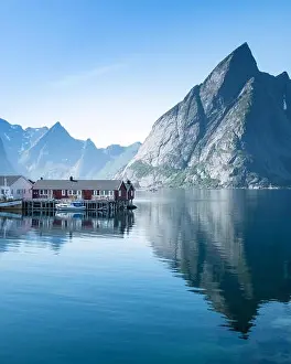 Scenic landscape with mountains and idyllic village at bright summer day in Lofoten Islands, Norway