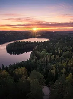 Scenic landscape with sunrise and lake at autumn in national park in Finland