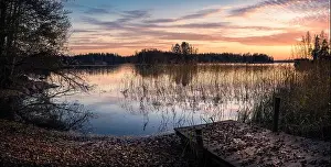 Scenic landscape with sunset and lake at autumn