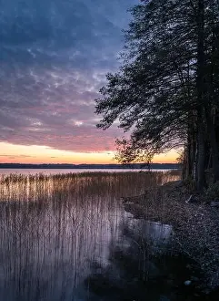 Scenic landscape with sunset and lake at autumn