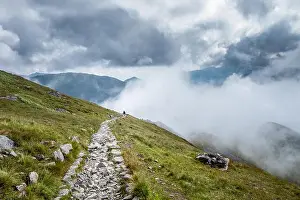 Low Clouds Prints: Scenic mountain view hiker at summer day in National park of Tatra mountains