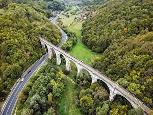 Scenic national road going under an old and disable train viaduct