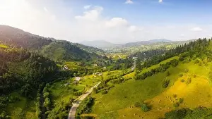 Eastern Beskids Prints: Scenic panoramic landscape. Aerial drone view of picturesque urban-type settlement in valley among green nature