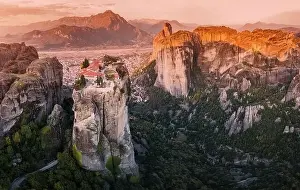 Kalambaka Prints: Scenic panoramic view of the Monastery of the Holy Trinity in Meteora at sunrise and Kalambaka town at the distance
