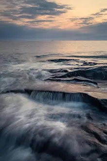 Scenic sea view with rocky coastline and sunset at autumn evening in Finland