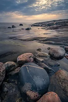 Scenic sea view with rocky coastline and sunset at autumn evening in Finland