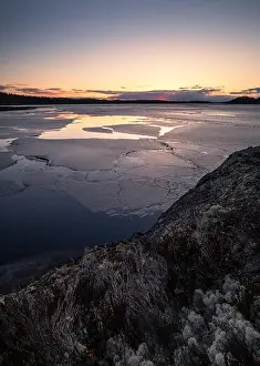 Atmospheric Mood Prints: Scenic spring landscape with melted ice and sunset at evening light in Finland